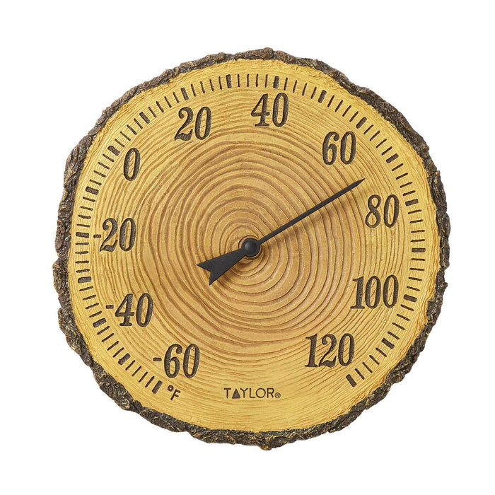 Round tree trunk cross section thermometer with visible growth rings and Fahrenheit scale around the edge