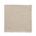 The Deborah Rhodes Herringbone Fringe Napkin Flax Set of 4 features light beige napkins with a subtle herringbone pattern and short fringe, reminiscent of a throw blanket, displayed on a white background.